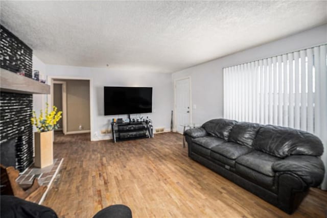 living room with hardwood / wood-style floors and a textured ceiling