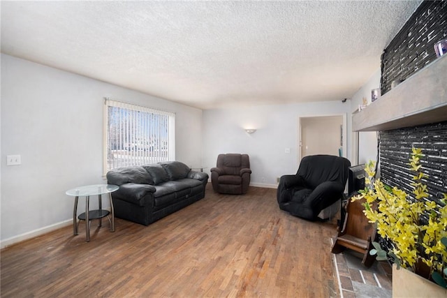 living room with hardwood / wood-style floors and a textured ceiling