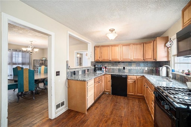 kitchen with light stone counters, sink, dark wood-type flooring, and black appliances