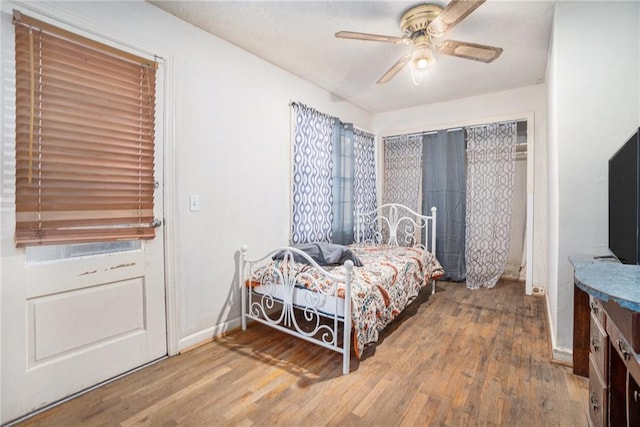 bedroom with ceiling fan and hardwood / wood-style floors