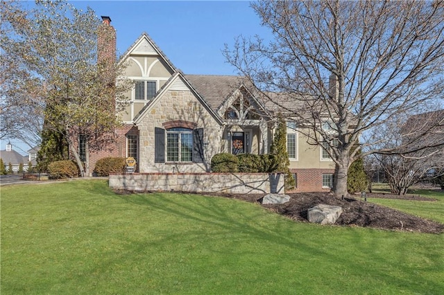 tudor home featuring a front yard