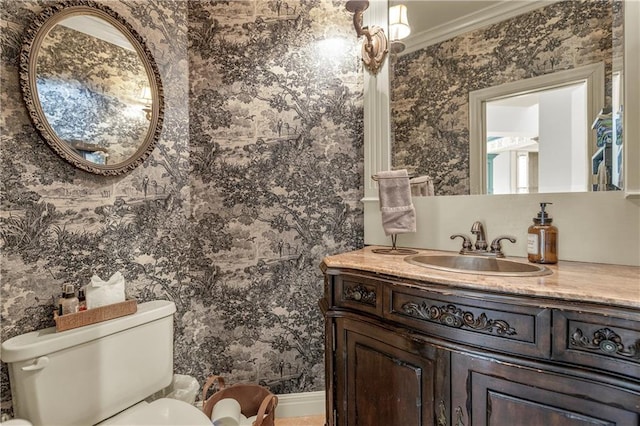 bathroom with ornamental molding, vanity, and toilet