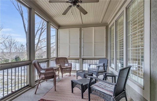 sunroom / solarium with wood ceiling, ceiling fan, and a wealth of natural light