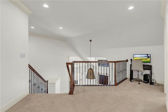 corridor with ornamental molding, vaulted ceiling, and light carpet