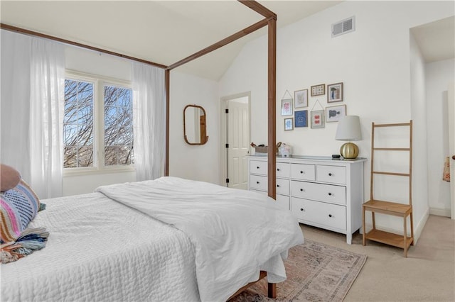 carpeted bedroom with lofted ceiling