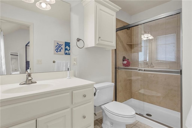 bathroom featuring toilet, vanity, and walk in shower