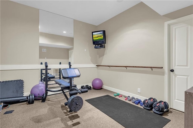 workout room featuring light carpet