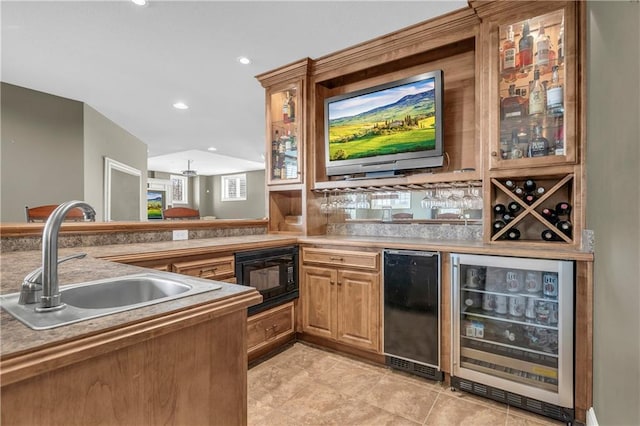 bar featuring wine cooler, sink, and black microwave