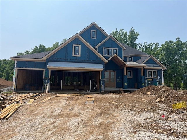 17028 Parkhill St, Overland Park, KS 66221 - view of front of house featuring a garage, dirt driveway, and french doors