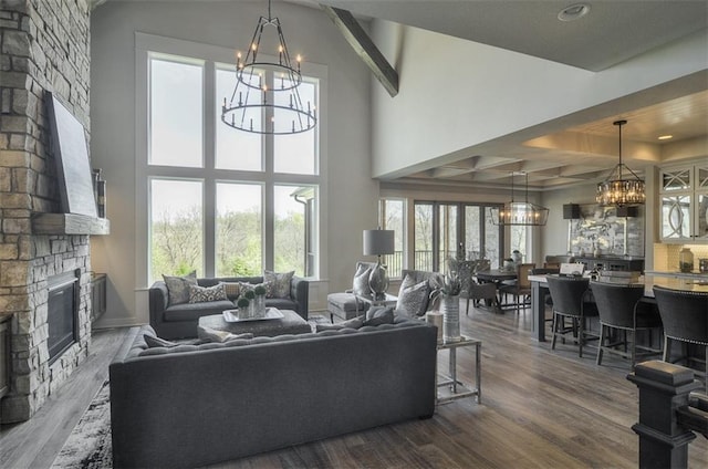 17028 Parkhill St, Overland Park, KS 66221 - living room with a chandelier, a fireplace, dark wood-type flooring, beam ceiling, and recessed lighting