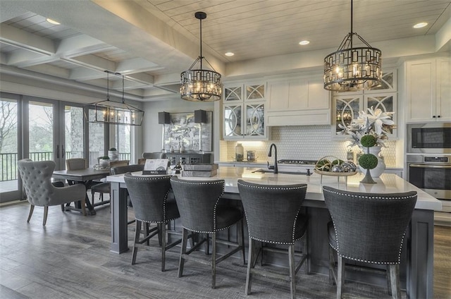 17028 Parkhill St, Overland Park, KS 66221 - kitchen with a chandelier, appliances with stainless steel finishes, backsplash, dark wood finished floors, and recessed lighting