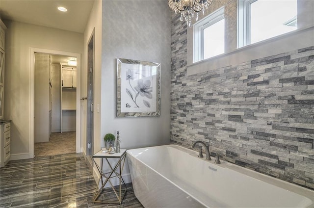 17028 Parkhill St, Overland Park, KS 66221 - bathroom with a freestanding bath, a chandelier, recessed lighting, and baseboards