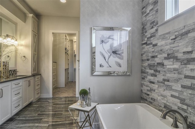 17028 Parkhill St, Overland Park, KS 66221 - full bath with a soaking tub, vanity, baseboards, and a closet