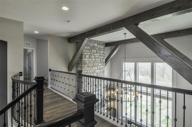 17028 Parkhill St, Overland Park, KS 66221 - hallway featuring wood finished floors, a chandelier, an upstairs landing, recessed lighting, and a textured ceiling