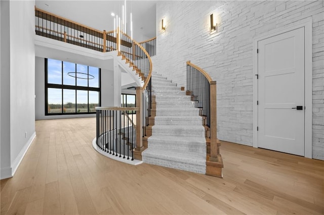 17028 Parkhill St, Overland Park, KS 66221 - stairway featuring wood finished floors, baseboards, and a towering ceiling