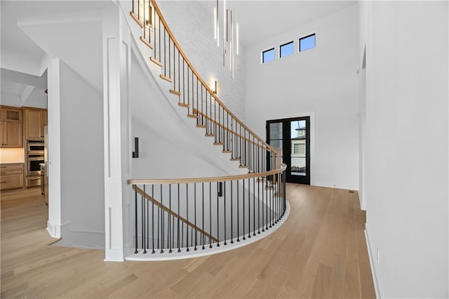 17028 Parkhill St, Overland Park, KS 66221 - foyer with a towering ceiling, light wood finished floors, plenty of natural light, and baseboards