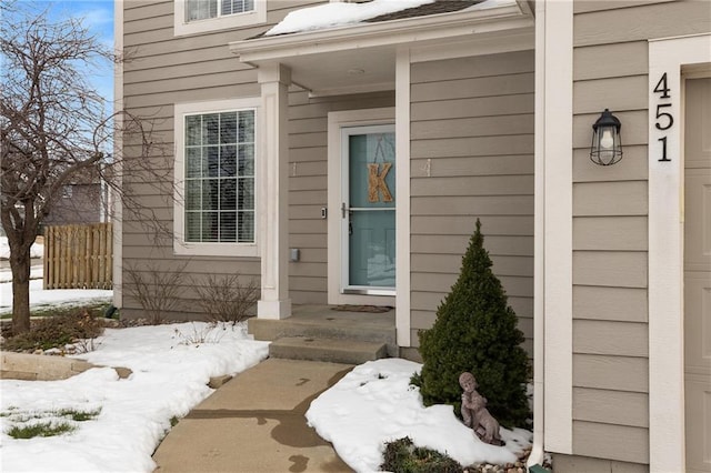 view of snow covered property entrance