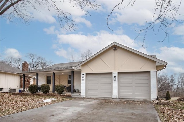 ranch-style home with a porch and a garage