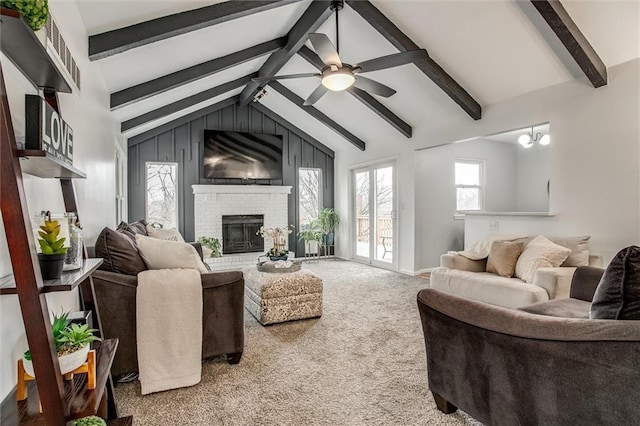 living room featuring a brick fireplace, vaulted ceiling with beams, ceiling fan, and carpet