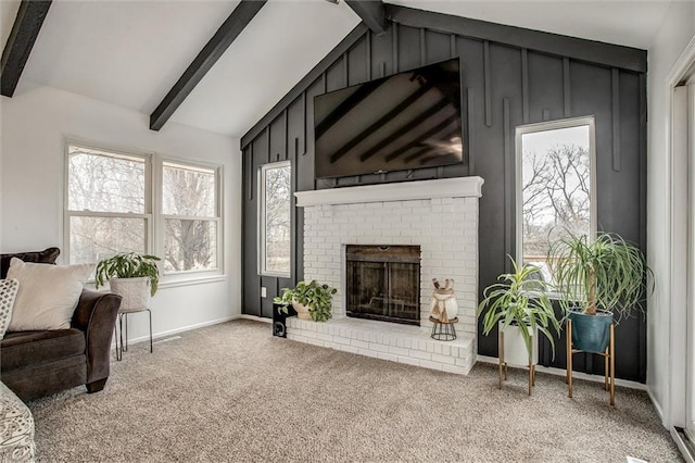 living room with a fireplace, carpet floors, and vaulted ceiling with beams