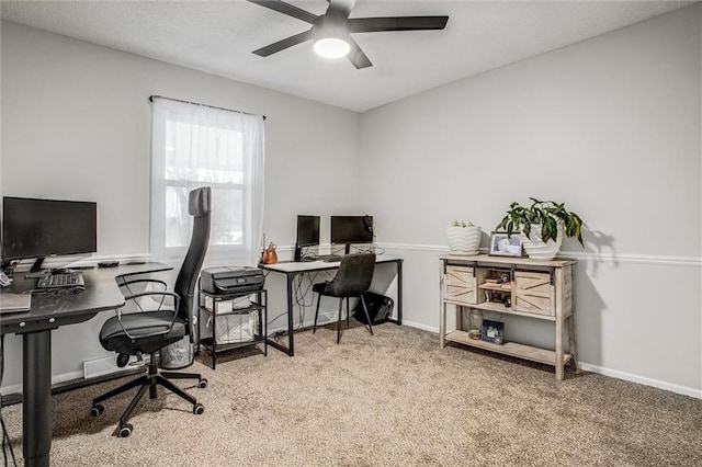 carpeted home office featuring ceiling fan