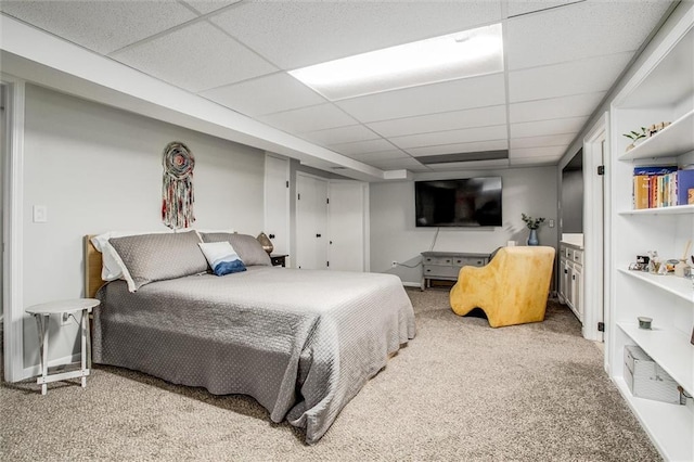 bedroom with a paneled ceiling and carpet flooring