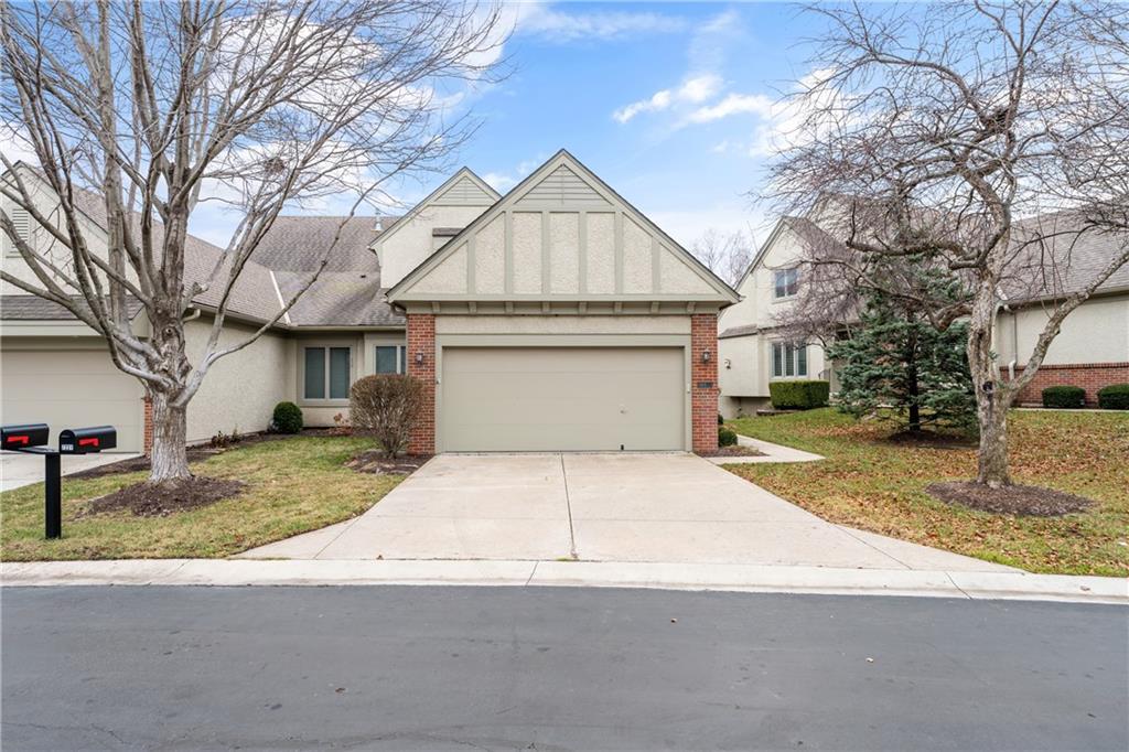 view of front of house with a front yard and a garage