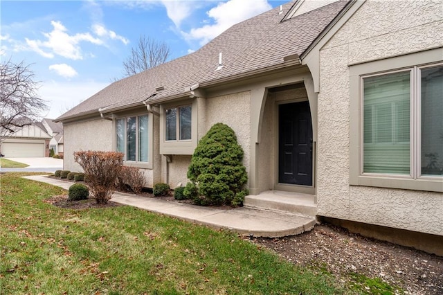 property entrance with a lawn