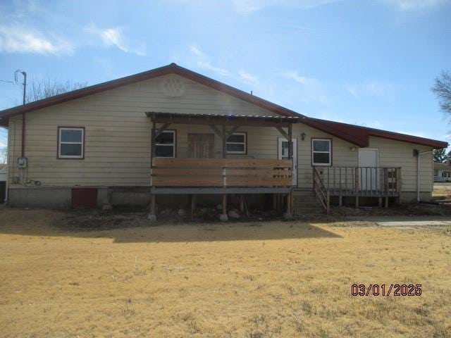 back of property featuring a deck