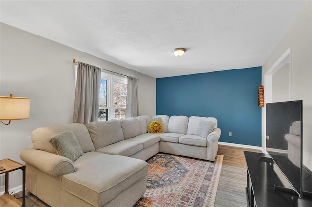 living room with light hardwood / wood-style flooring and a textured ceiling