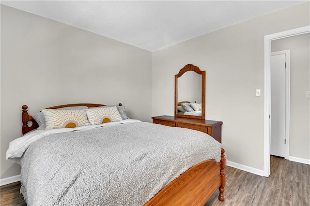 bedroom with dark hardwood / wood-style flooring