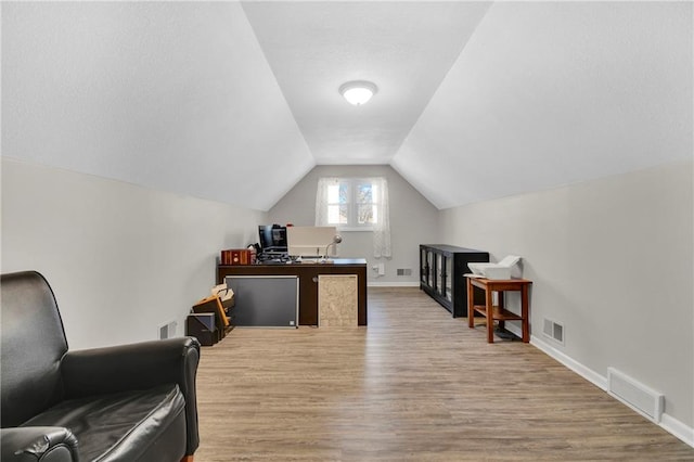 office featuring hardwood / wood-style flooring and vaulted ceiling