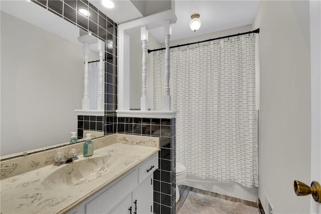 bathroom with vanity, toilet, and a shower with shower curtain