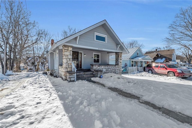 bungalow-style home with a garage and a porch