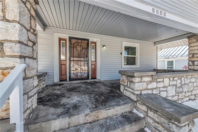 view of exterior entry featuring a porch