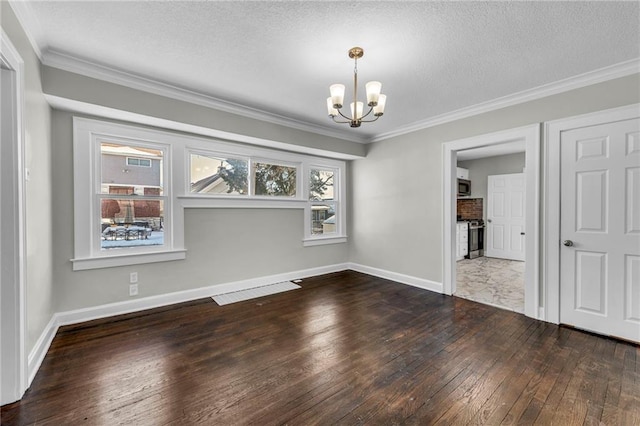 unfurnished dining area featuring hardwood / wood-style floors, crown molding, and a chandelier