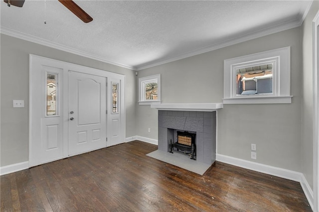 unfurnished living room with ornamental molding, a textured ceiling, ceiling fan, and dark hardwood / wood-style flooring