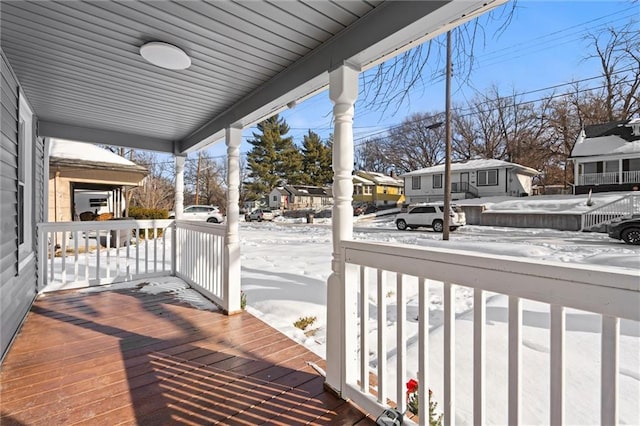 snow covered deck with covered porch