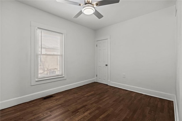 unfurnished room with dark hardwood / wood-style floors and ceiling fan