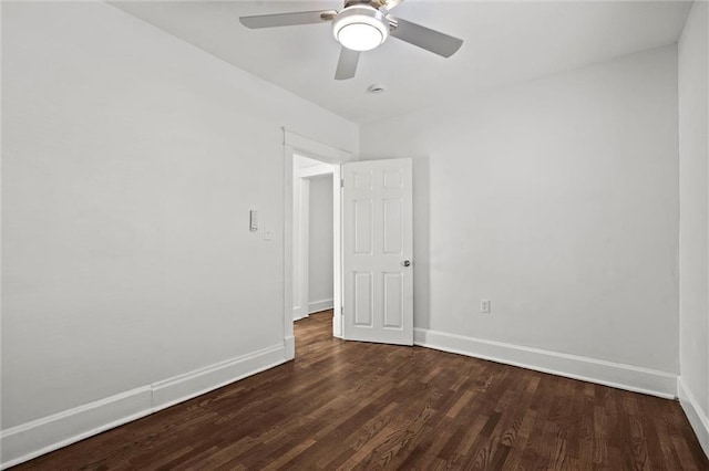 spare room featuring ceiling fan and dark hardwood / wood-style floors