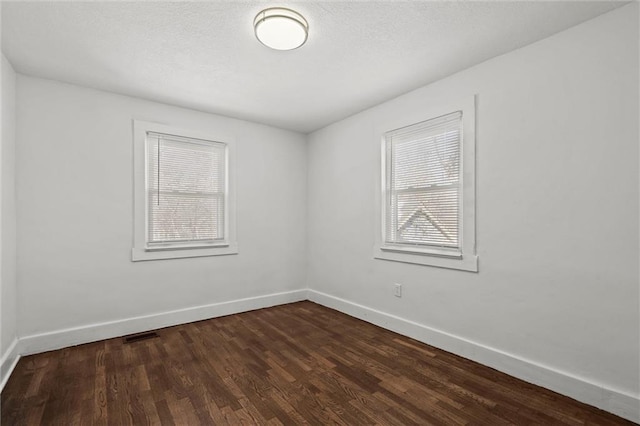 empty room with dark wood-type flooring