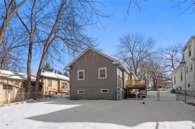 snow covered property with a wooden deck