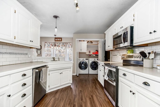 kitchen with white cabinets, separate washer and dryer, hanging light fixtures, and appliances with stainless steel finishes