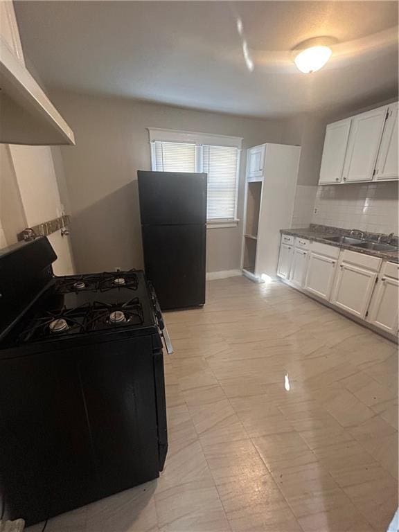 kitchen with sink, extractor fan, white cabinets, and black appliances