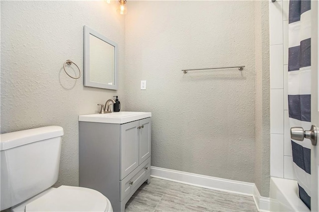 full bathroom featuring toilet, vanity, and  shower combination