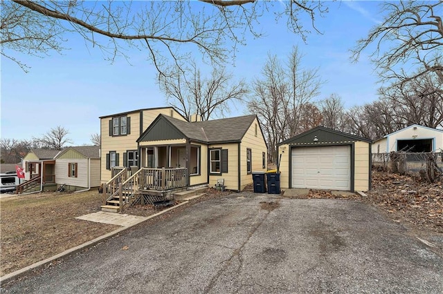 view of front of house featuring a garage, an outbuilding, and covered porch