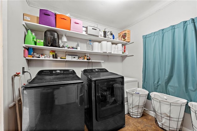 clothes washing area featuring washing machine and clothes dryer