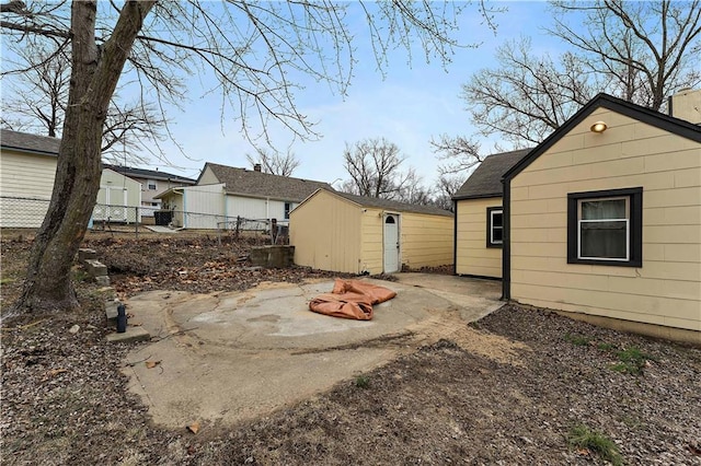 exterior space with a storage shed and a patio area