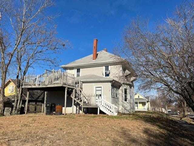 back of house featuring a wooden deck