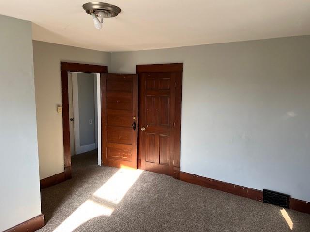 empty room with dark carpet